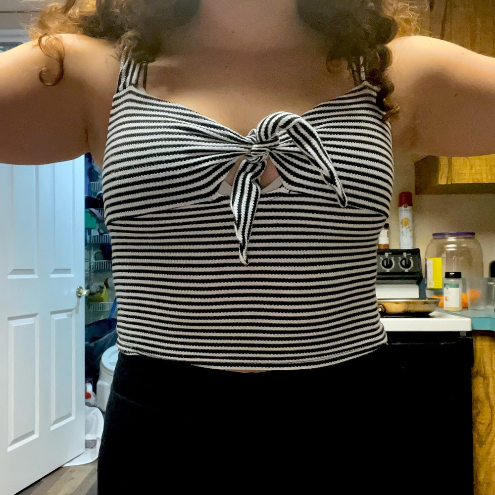 Striped tank top with a tie in the front. In good condition.
